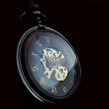 A close-up of an antique pocket watch with gold details and Roman numerals, symbolizing time management in Daily Journaling for Leadership.