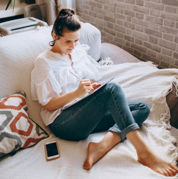 Bullet Journaling for Productivity. Woman, couch
