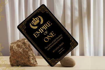 Self-improvement ebook EMPIRE OF ONE by Luca Wolf on a decorative background with stones.